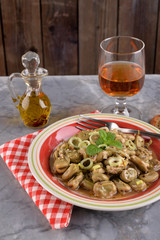Dish of broad beans stewed with onion and oregano and mint on the marble table
