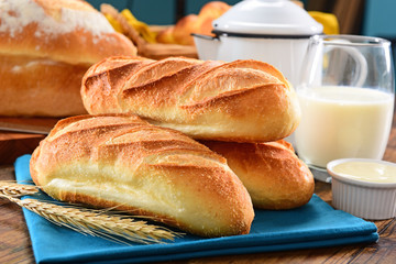 Fresh baguettes on wooden background