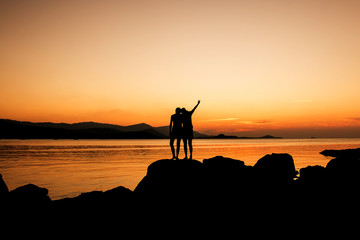 Relax time of sister on the beach sunset background