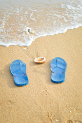 Fototapeta na wymiar Top view on flip flops ans beach outdoors background. Summer vacation idea