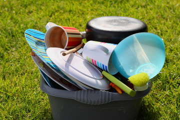 Dirty plates and dishes on a campsite waiting to be washed up