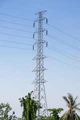 High voltage post or power transmission line tower and blue sky
