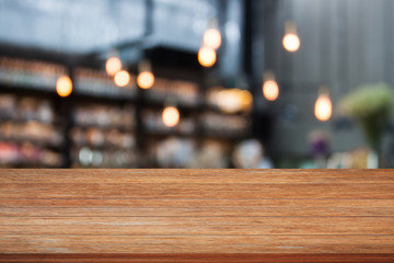 Top wooden table with cafe background