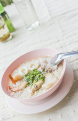Boiled rice seafood with shrimp, squid, snapper or mush delicious breakfast Thai food.