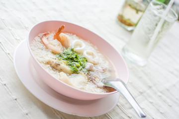 Boiled rice seafood with shrimp, squid, snapper or mush delicious breakfast Thai food.