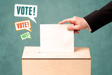 placing a voting slip into a ballot box