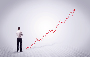 Standing businessman with red graph arrow