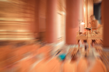 Blurred zoom of Thai monk worship in temple
