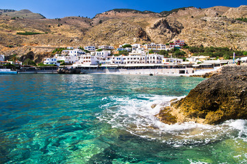 Landscape, mountains and view of a small harbor with village at Lybian sea coast, south side of Crete island, Greece