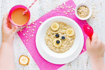 Healthy baby breakfast - oatmeal porridge with fruit
