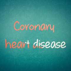 Green blackboard wall texture with a word Coronary Heart Disease