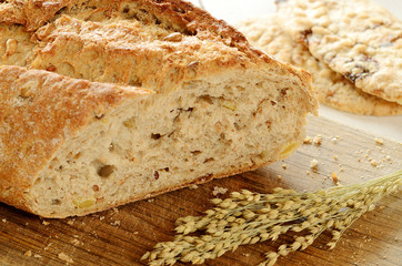 Close-up of fresh wheat bread  on wooden cutting board