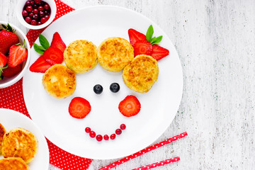 Creative baby breakfast - cheese pancakes with berry