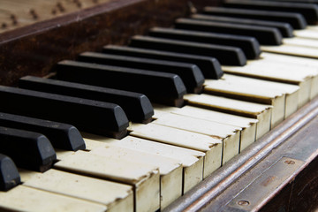 Old broken disused piano with damaged keys