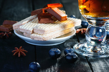 Waffle, chocolate pieces, blueberry and tea