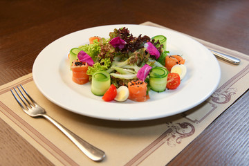 Fresh salad with chicken, tomatoes and mixed greens