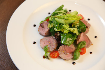 Fresh salad with chicken, tomatoes and mixed greens
