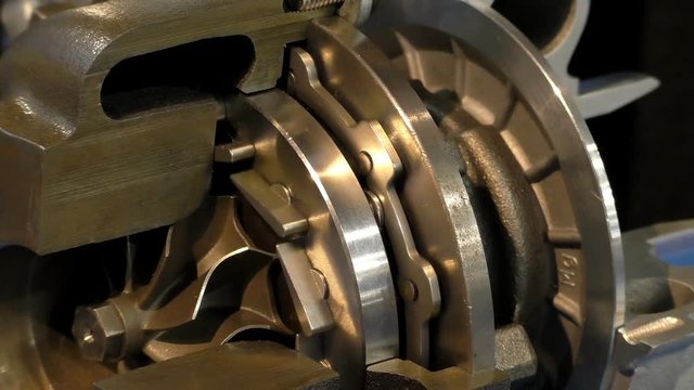 Close view of cutaway car diesel engine turbocharger.Showing moving inside parts, seamless loop