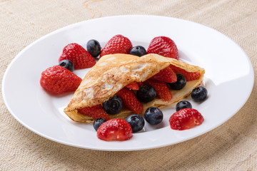 fruit pancake on white plate