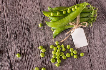 peas on a wood table with tag