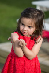 Little girl playing alone in garden