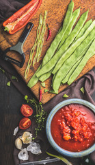 French green beans cooking. Preparation of  green beans and vegetables ingredients on rustic kitchen table, top view. Vegetables eating food concept.
