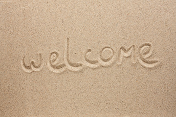 Welcome is the inscription by hand on the sand