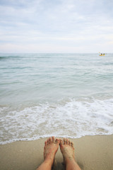 Fototapeta na wymiar Sandy Woman Feet on the beach,Thailand