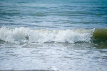 Blue waves of the sea and foam background, reflections of sun light