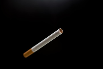 blurred cigarette and black background