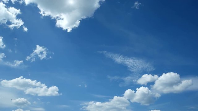 Time lapse clip of white fluffy clouds over blue sky. Beautiful cloudscape.