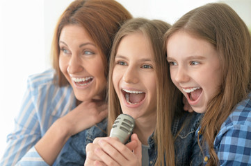mother and daughters singing karaoke
