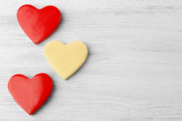 Wooden hearts on light background