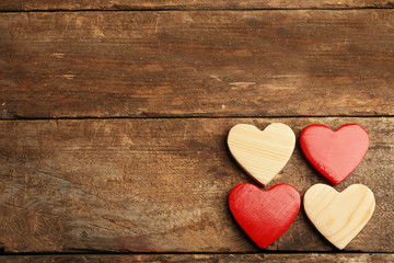 Wooden hearts on rustic wooden background