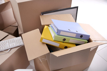 Move concept. Unpacking cardboard boxes in a new office