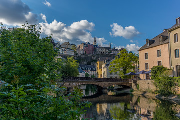 Stone bridge reflecting in the Alzette river in the city of Luxe