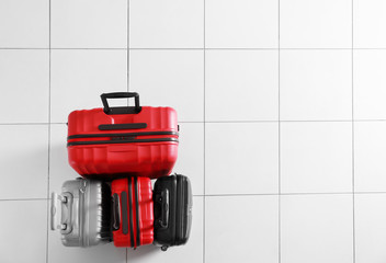 Different suitcases on tile floor, top view