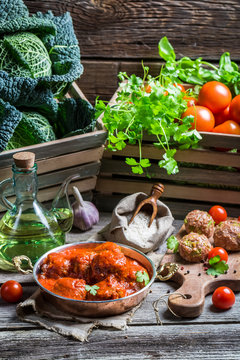 Meatballs with tomato sauce and parsley and ingredients