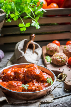 Tasty meatballs with tomato sauce and parsley