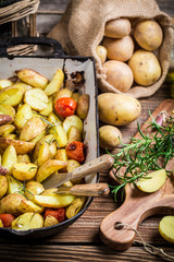 Baked potatoes with rosemary, garlic and cherry tomatoes