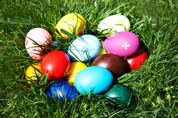 Coloured Easter eggs on green grass, closeup