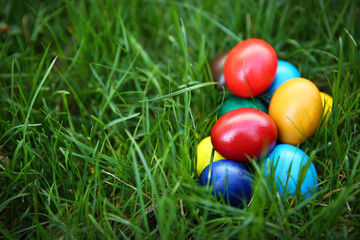 Fototapeta na wymiar Coloured Easter eggs on green grass, closeup