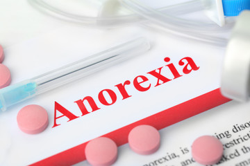 Anorexia concept. Medical supplies on paper background