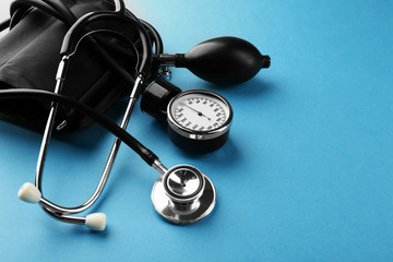Medical manometer and a stethoscope on blue background