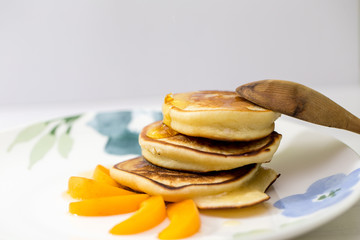 Fototapeta na wymiar pancakes with honey and apricot