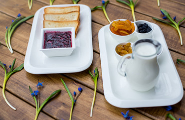 Healthy breakfast with dried fruits on wooden background