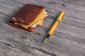 Wallet with pen on a wood table