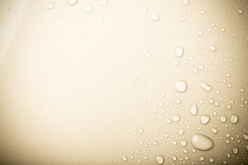 Drops of water on a color background. Beige. Shallow depth of fi