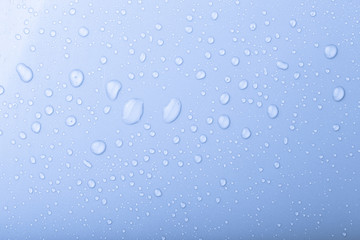 Drops of water on a color background. Blue. Shallow depth of fie