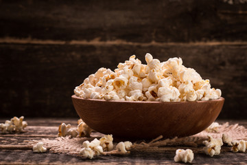 A bowl of popcorn on a wooden table